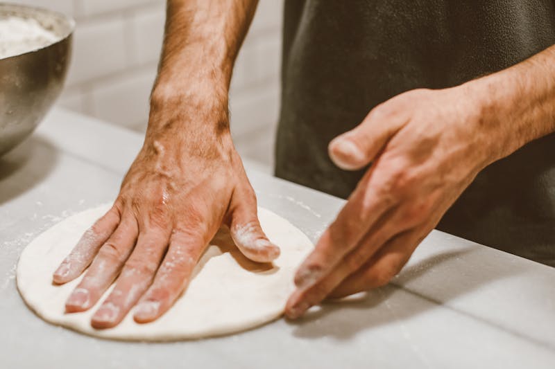 Traditional pizza preparation at Marcos
